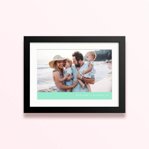 Framed and mounted photo print with a family of four on the beach.