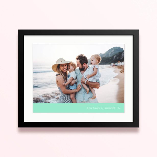 Framed and mounted photo print with a family of four on the beach.