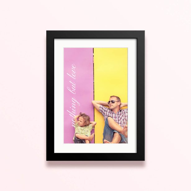 Framed and mounted photo print with two people relaxing against a colourful background.