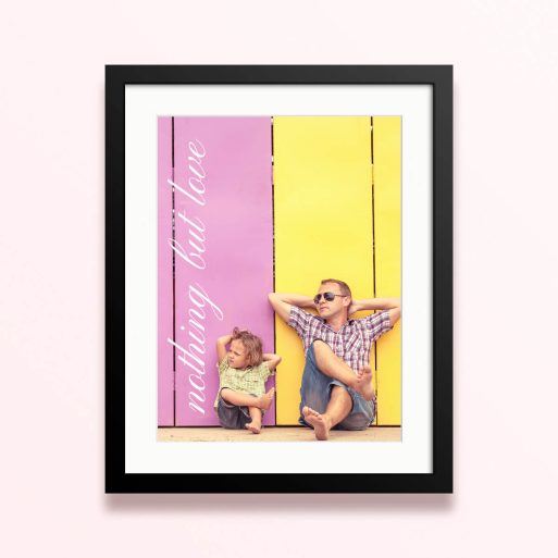 Framed and mounted photo print with two people relaxing against a colourful background.