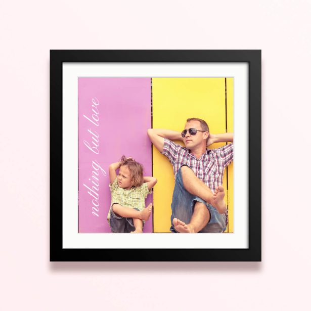 Framed and mounted photo print with two people relaxing against a colourful background.