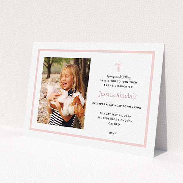 A communion invitation template titled "Baby Pink Cross". It is an A6 invite in a landscape orientation. It is a photographic communion invitation with room for 1 photo. "Baby Pink Cross" is available as a flat invite, with tones of pink and white.