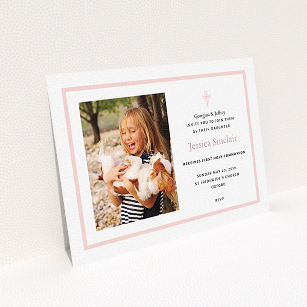 A communion invitation template titled "Baby Pink Cross". It is an A6 invite in a landscape orientation. It is a photographic communion invitation with room for 1 photo. "Baby Pink Cross" is available as a flat invite, with tones of pink and white.