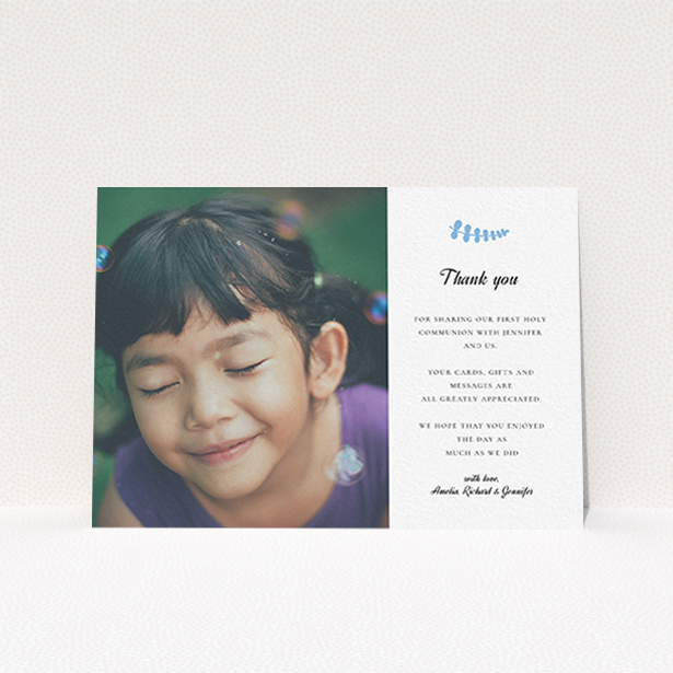 A communion thank you card design named "Blue Fern". It is an A6 card in a landscape orientation. It is a photographic communion thank you card with room for 1 photo. "Blue Fern" is available as a flat card, with tones of white and blue.