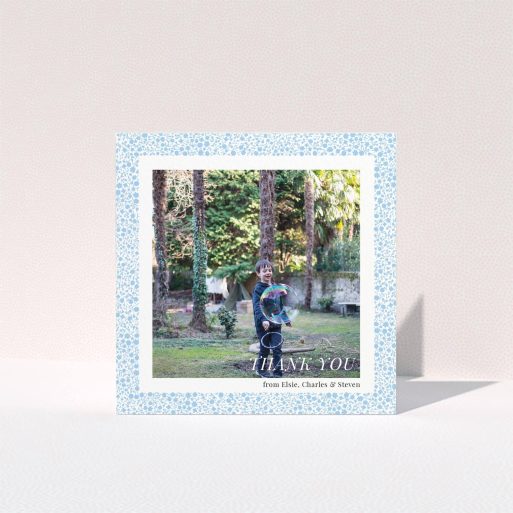 Communion Thank You Card Design - "Blue Floral Frame" A communion thank you card design titled "Blue Floral Frame". It is a square (148mm x 148mm) card in a square orientation. It is a photographic communion thank you card with room for 1 photo. "Blue Floral Frame" is available as a folded card, with tones of blue and white.