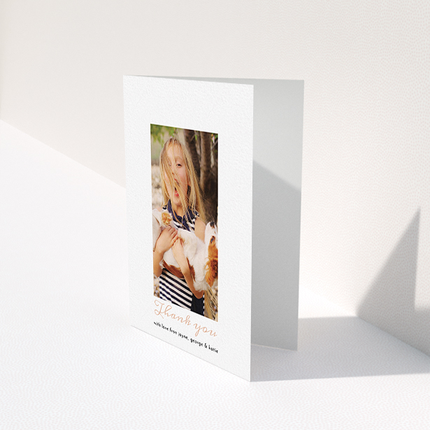 A communion thank you card template titled "Central Portrait". It is an A6 card in a portrait orientation. It is a photographic communion thank you card with room for 1 photo. "Central Portrait" is available as a folded card, with tones of white and pink.