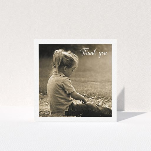 A communion thank you card design named "Centralised Frame". It is a square (148mm x 148mm) card in a square orientation. It is a photographic communion thank you card with room for 1 photo. "Centralised Frame" is available as a folded card, with mainly white colouring.