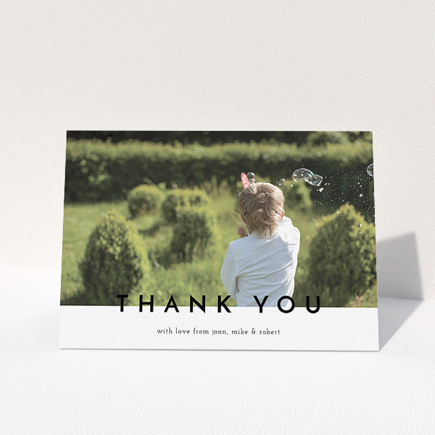 A communion thank you card named "Cross Border". It is an A5 card in a landscape orientation. It is a photographic communion thank you card with room for 1 photo. "Cross Border" is available as a folded card, with mainly white colouring.