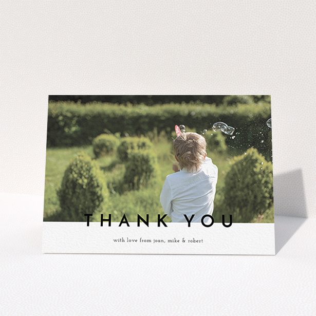 A communion thank you card design titled "Cross Border". It is an A6 card in a landscape orientation. It is a photographic communion thank you card with room for 1 photo. "Cross Border" is available as a folded card, with mainly white colouring.