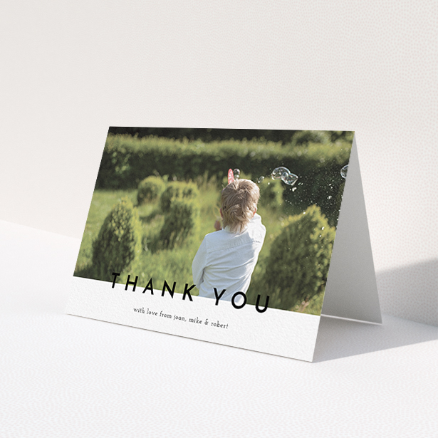 A communion thank you card design titled 'Cross Border'. It is an A6 card in a landscape orientation. It is a photographic communion thank you card with room for 1 photo. 'Cross Border' is available as a folded card, with mainly white colouring.