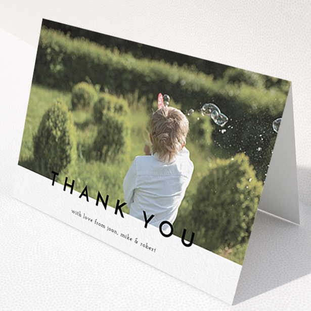 A communion thank you card design titled "Cross Border". It is an A6 card in a landscape orientation. It is a photographic communion thank you card with room for 1 photo. "Cross Border" is available as a folded card, with mainly white colouring.