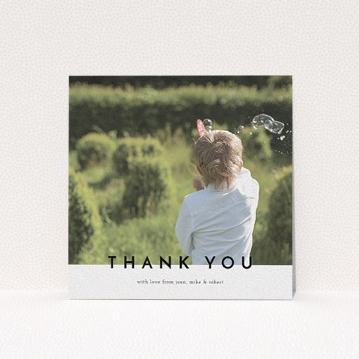 A communion thank you card template titled "Cross Border". It is a square (148mm x 148mm) card in a square orientation. It is a photographic communion thank you card with room for 1 photo. "Cross Border" is available as a flat card, with mainly white colouring.