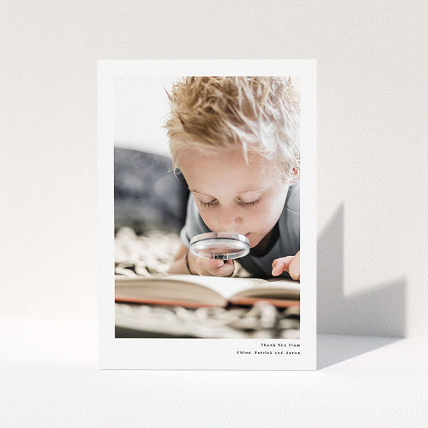 A communion thank you card named "Simple Portrait". It is an A5 card in a portrait orientation. It is a photographic communion thank you card with room for 1 photo. "Simple Portrait" is available as a folded card, with mainly white colouring.
