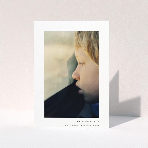 Communion Thank You Card Design - "Thin Blue Frame" A communion thank you card called "Thin Blue Frame". It is an A5 card in a portrait orientation. It is a photographic communion thank you card with room for 1 photo. "Thin Blue Frame" is available as a folded card, with mainly white colouring.