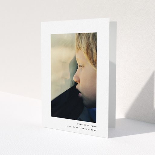 A communion thank you card called 'Thin Blue Frame'. It is an A5 card in a portrait orientation. It is a photographic communion thank you card with room for 1 photo. 'Thin Blue Frame' is available as a folded card, with mainly white colouring.