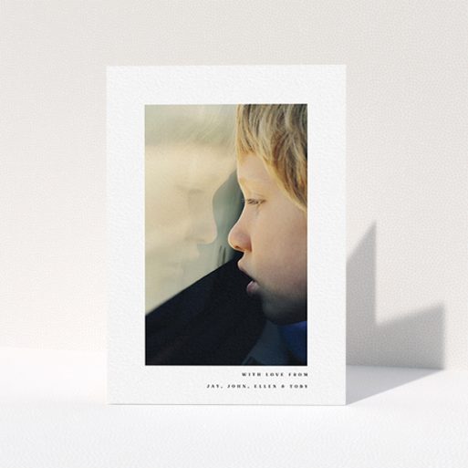 A communion thank you card template titled "Thin Blue Frame". It is an A6 card in a portrait orientation. It is a photographic communion thank you card with room for 1 photo. "Thin Blue Frame" is available as a folded card, with mainly white colouring.