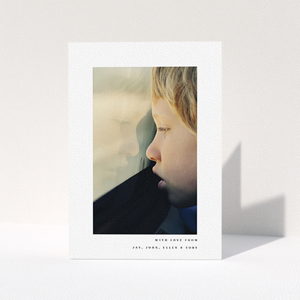A communion thank you card template titled "Thin Blue Frame". It is an A6 card in a portrait orientation. It is a photographic communion thank you card with room for 1 photo. "Thin Blue Frame" is available as a folded card, with mainly white colouring.