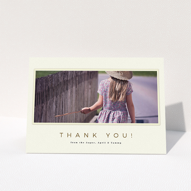 A communion thank you card design titled "Torn Cream Frame". It is an A5 card in a landscape orientation. It is a photographic communion thank you card with room for 1 photo. "Torn Cream Frame" is available as a folded card, with mainly cream colouring.