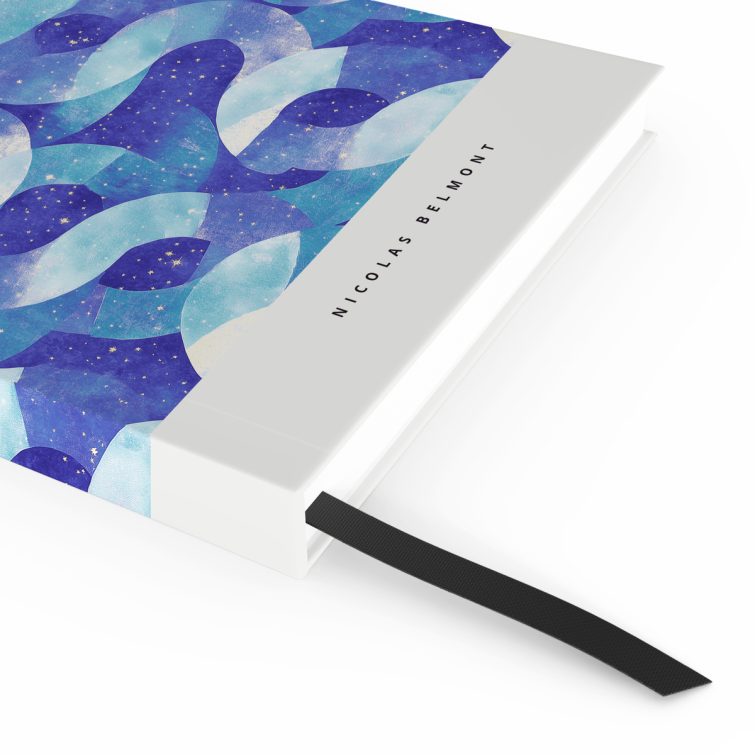 Abstract blue and turquoise pattern notebook design with starry elements on cover spread, no photos present.