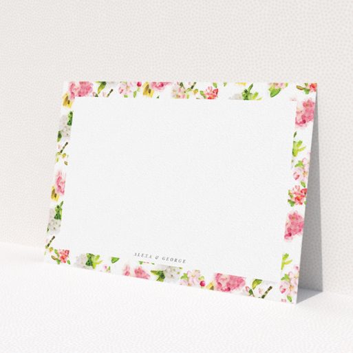 A couples personalised note card design named 'Blurred blossom'. It is an A5 card in a landscape orientation. 'Blurred blossom' is available as a flat card, with tones of pink, green and yellow.