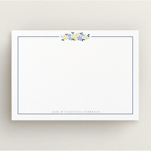 Personalised Note Card Design (Couples) - "Surrounded by flowers" A couples personalised note card design called "Surrounded by flowers". It is an A5 card in a landscape orientation. "Surrounded by flowers" is available as a flat card, with tones of white and blue.