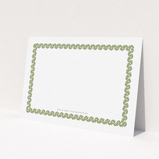 A couples personalised note card design called 'Surrounded by the garden'. It is an A5 card in a landscape orientation. 'Surrounded by the garden' is available as a flat card, with mainly green colouring.