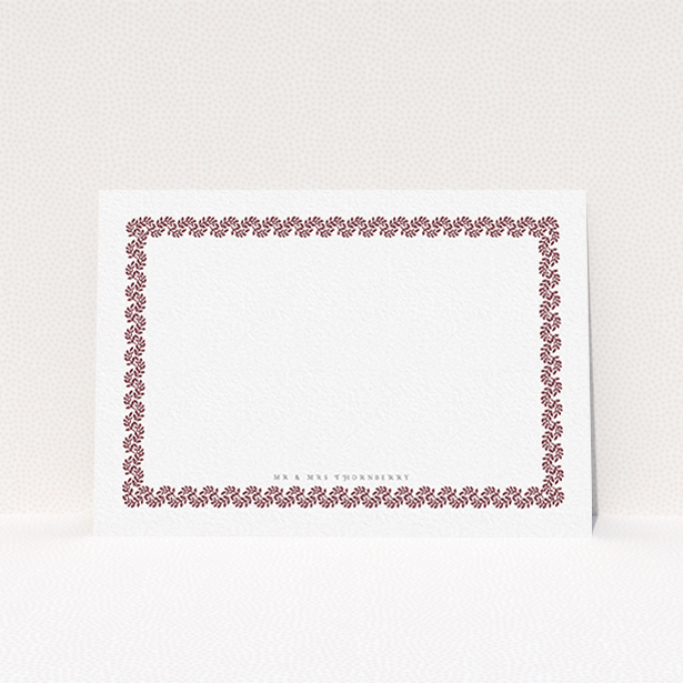 A couples personalised note card named "Surrounded by the garden maroon". It is an A6 card in a landscape orientation. "Surrounded by the garden maroon" is available as a flat card, with tones of burgundy and white.