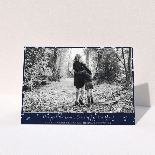 A custom christmas card design called "Falling Snow at Night". It is an A5 card in a landscape orientation. It is a photographic custom christmas card with room for 1 photo. "Falling Snow at Night" is available as a folded card, with tones of blue and white.