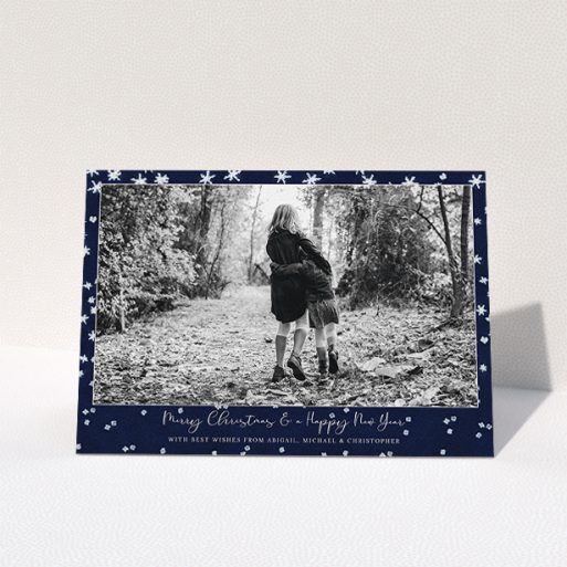 A custom christmas card design called "Falling Snow at Night". It is an A5 card in a landscape orientation. It is a photographic custom christmas card with room for 1 photo. "Falling Snow at Night" is available as a folded card, with tones of blue and white.