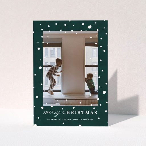 A custom christmas card called "Forrest Snow". It is an A5 card in a portrait orientation. It is a photographic custom christmas card with room for 1 photo. "Forrest Snow" is available as a folded card, with mainly green colouring.
