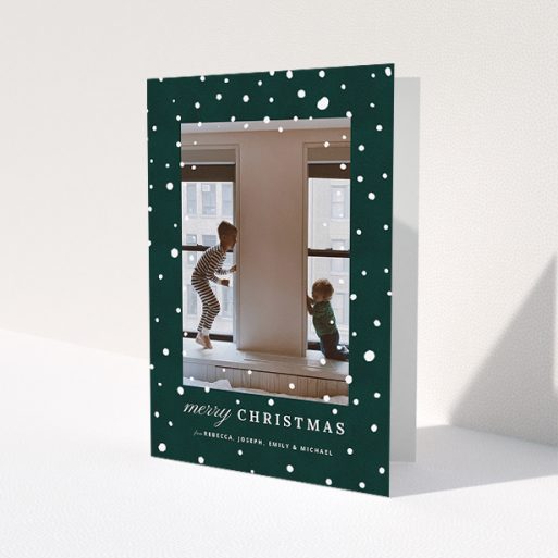 A custom christmas card called 'Forrest Snow'. It is an A5 card in a portrait orientation. It is a photographic custom christmas card with room for 1 photo. 'Forrest Snow' is available as a folded card, with mainly green colouring.
