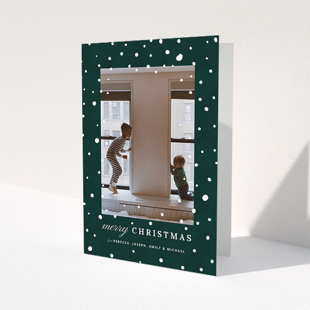 A custom christmas card called "Forrest Snow". It is an A5 card in a portrait orientation. It is a photographic custom christmas card with room for 1 photo. "Forrest Snow" is available as a folded card, with mainly green colouring.