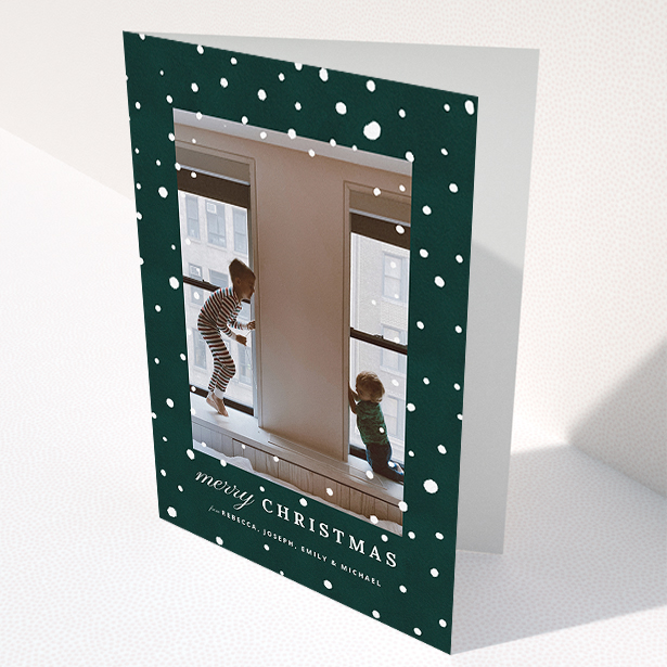 A custom christmas card called "Forrest Snow". It is an A5 card in a portrait orientation. It is a photographic custom christmas card with room for 1 photo. "Forrest Snow" is available as a folded card, with mainly green colouring.