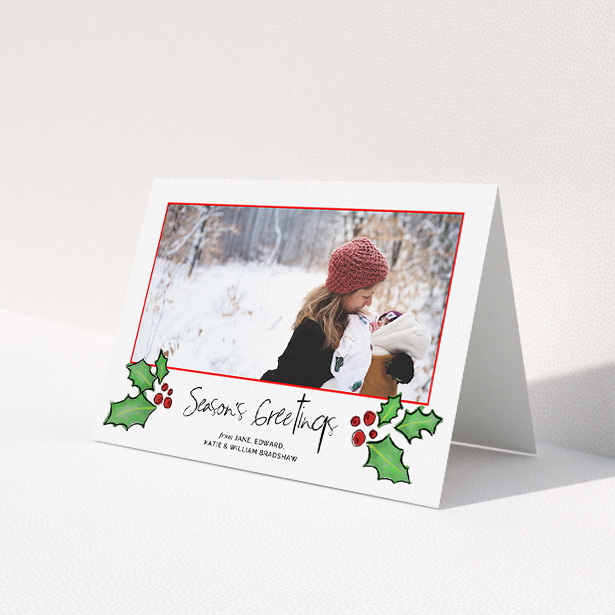 A custom christmas card design named 'Holly Sides'. It is an A5 card in a landscape orientation. It is a photographic custom christmas card with room for 1 photo. 'Holly Sides' is available as a folded card, with tones of white, green and red.