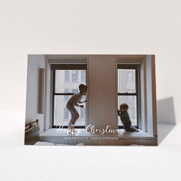 A custom christmas card called "Photo Message". It is an A5 card in a landscape orientation. It is a photographic custom christmas card with room for 1 photo. "Photo Message" is available as a folded card, with mainly white colouring.
