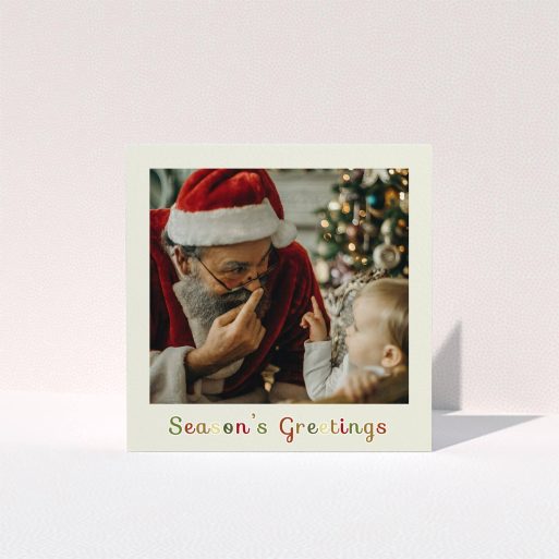 A custom christmas card named "Season's Greetings". It is a square (148mm x 148mm) card in a square orientation. It is a photographic custom christmas card with room for 1 photo. "Season's Greetings" is available as a folded card, with tones of cream, red and yellow.