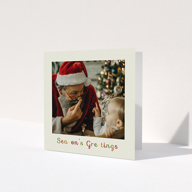 A custom christmas card named 'Season's Greetings'. It is a square (148mm x 148mm) card in a square orientation. It is a photographic custom christmas card with room for 1 photo. 'Season's Greetings' is available as a folded card, with tones of cream, red and yellow.