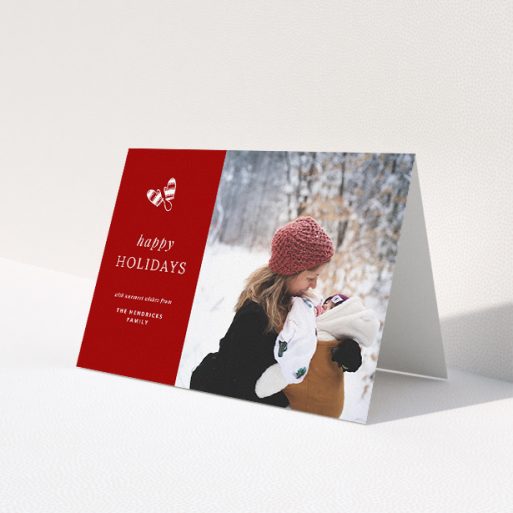 A custom christmas card design named 'Warm Mittens'. It is an A5 card in a landscape orientation. It is a photographic custom christmas card with room for 1 photo. 'Warm Mittens' is available as a folded card, with tones of red and white.