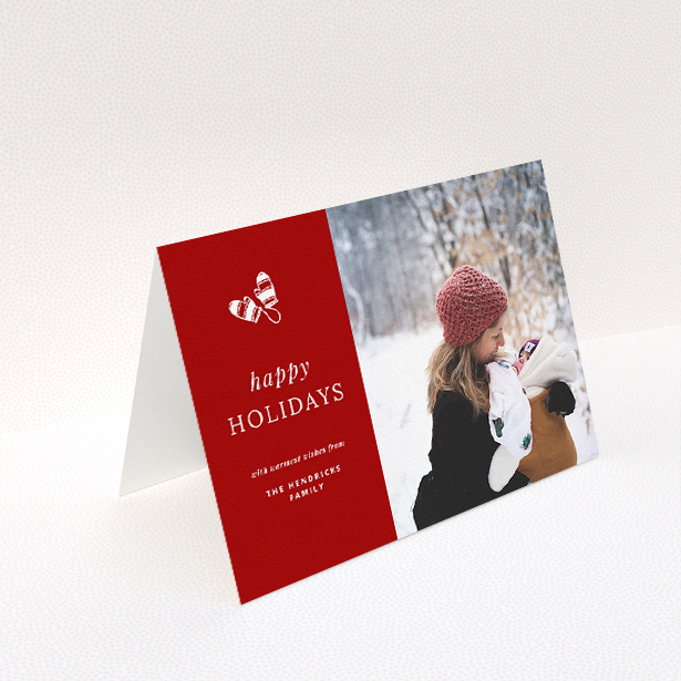 A custom christmas card design named "Warm Mittens". It is an A5 card in a landscape orientation. It is a photographic custom christmas card with room for 1 photo. "Warm Mittens" is available as a folded card, with tones of red and white.