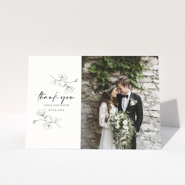 Wedding thank you card with floral illustrations and one photo of a smiling couple