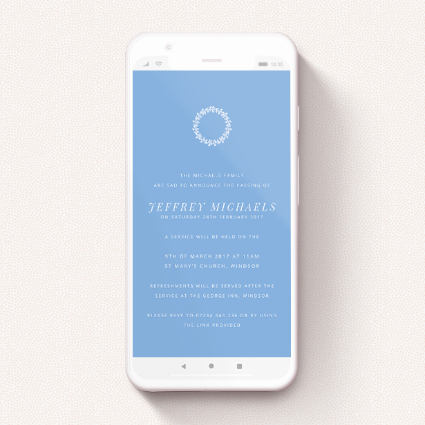 A digital funeral invite design called "Floral Wreath in White". It is a smartphone screen sized invite in a portrait orientation. "Floral Wreath in White" is available as a flat invite, with tones of blue and white.
