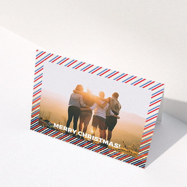 A family christmas card called "Bold Christmas Border". It is an A6 card in a landscape orientation. It is a photographic family christmas card with room for 1 photo. "Bold Christmas Border" is available as a folded card, with mainly white colouring.