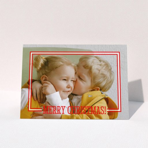 A family christmas card called "Christmas Border". It is an A5 card in a landscape orientation. It is a photographic family christmas card with room for 1 photo. "Christmas Border" is available as a folded card, with mainly red colouring.
