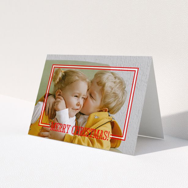 A family christmas card called 'Christmas Border'. It is an A5 card in a landscape orientation. It is a photographic family christmas card with room for 1 photo. 'Christmas Border' is available as a folded card, with mainly red colouring.