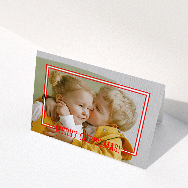 A family christmas card called "Christmas Border". It is an A5 card in a landscape orientation. It is a photographic family christmas card with room for 1 photo. "Christmas Border" is available as a folded card, with mainly red colouring.