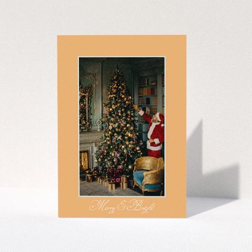 A family christmas card design titled "Clementine and Candle". It is an A5 card in a portrait orientation. It is a photographic family christmas card with room for 1 photo. "Clementine and Candle" is available as a folded card, with tones of orange and blue.