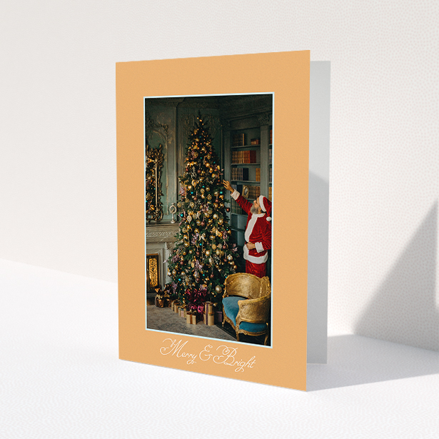 A family christmas card design titled 'Clementine and Candle'. It is an A5 card in a portrait orientation. It is a photographic family christmas card with room for 1 photo. 'Clementine and Candle' is available as a folded card, with tones of orange and blue.