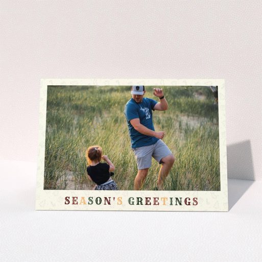 A family christmas card template titled "Dickensian". It is an A5 card in a landscape orientation. It is a photographic family christmas card with room for 1 photo. "Dickensian" is available as a folded card, with tones of cream, red and dark green.