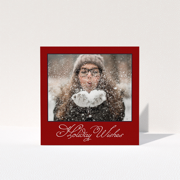 A family christmas card template titled "Fanned Deep Red". It is a square (148mm x 148mm) card in a square orientation. It is a photographic family christmas card with room for 1 photo. "Fanned Deep Red" is available as a folded card, with tones of burgundy and white.