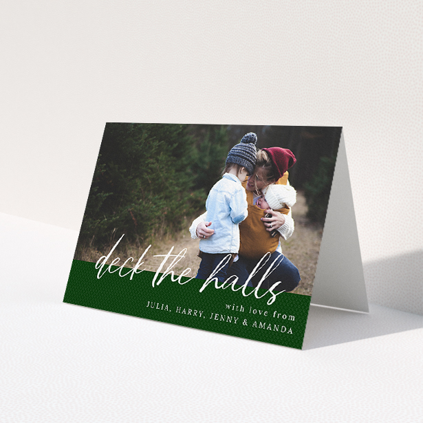 A family christmas card called 'Forrest Green Feelings'. It is an A5 card in a landscape orientation. It is a photographic family christmas card with room for 1 photo. 'Forrest Green Feelings' is available as a folded card, with mainly green colouring.